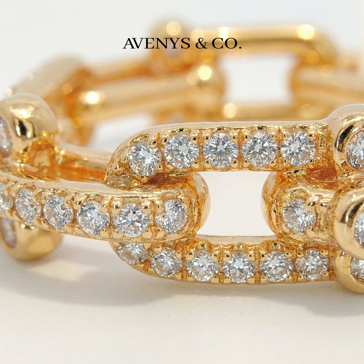 Interlock Pave Ring with White Round Stone – on Yellow Gold