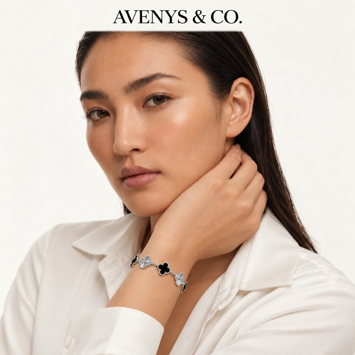 AV Bloom™ Black & Silver Sunburst Bracelet with a white blouse