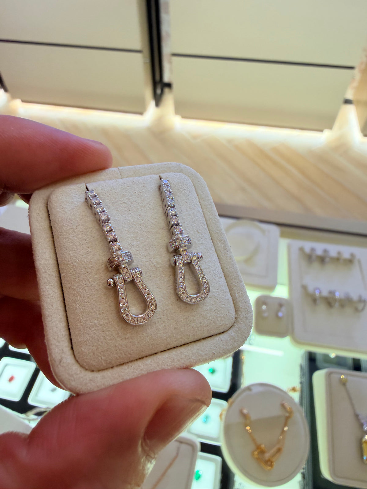 Original owner reference — White Gold U Link Drop Earrings in the foreground. Background jewellery and the display holder are not included.